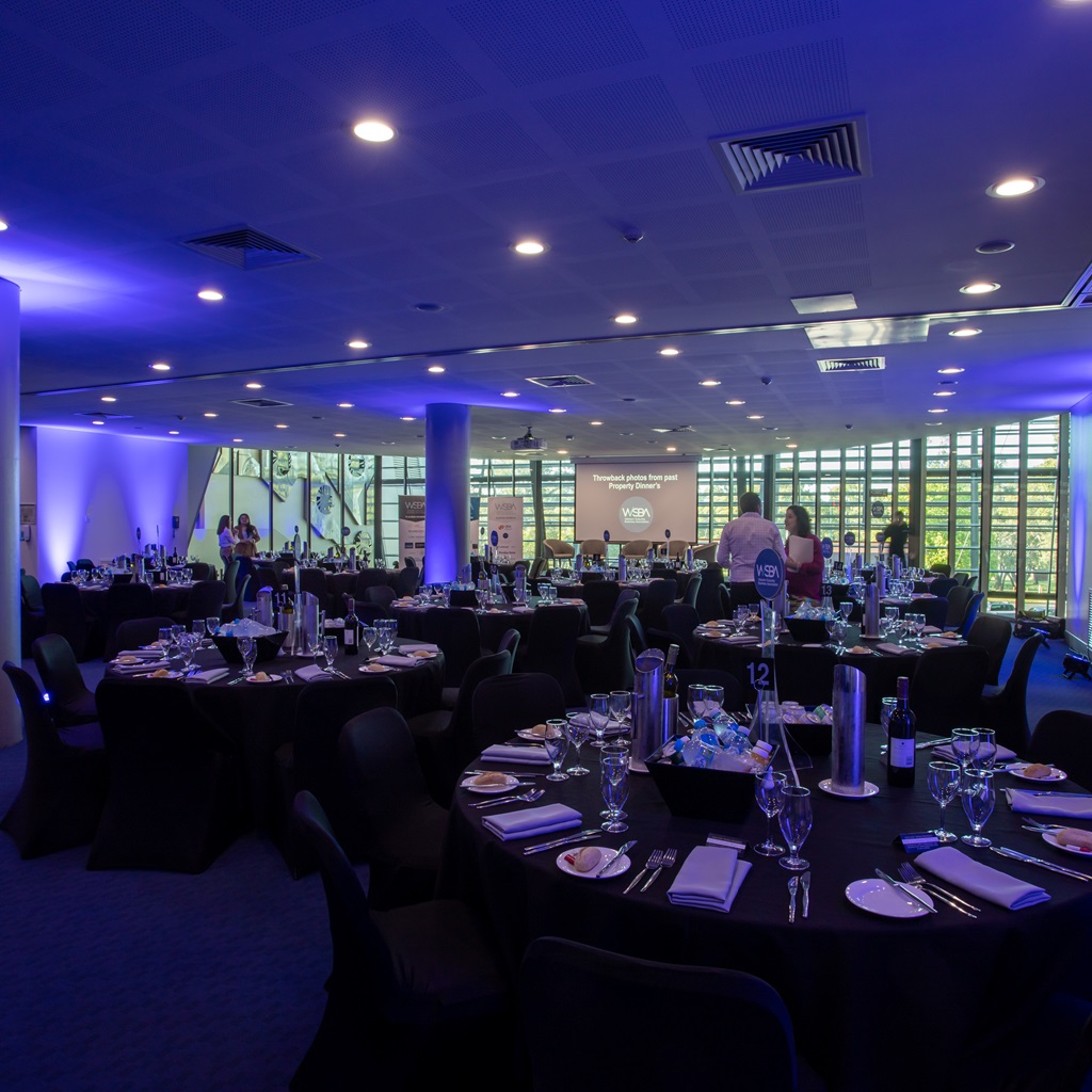 A photo of tables and glassware set up in a function room at the Bendat Basketball Centre in Mount Claremont, Perth